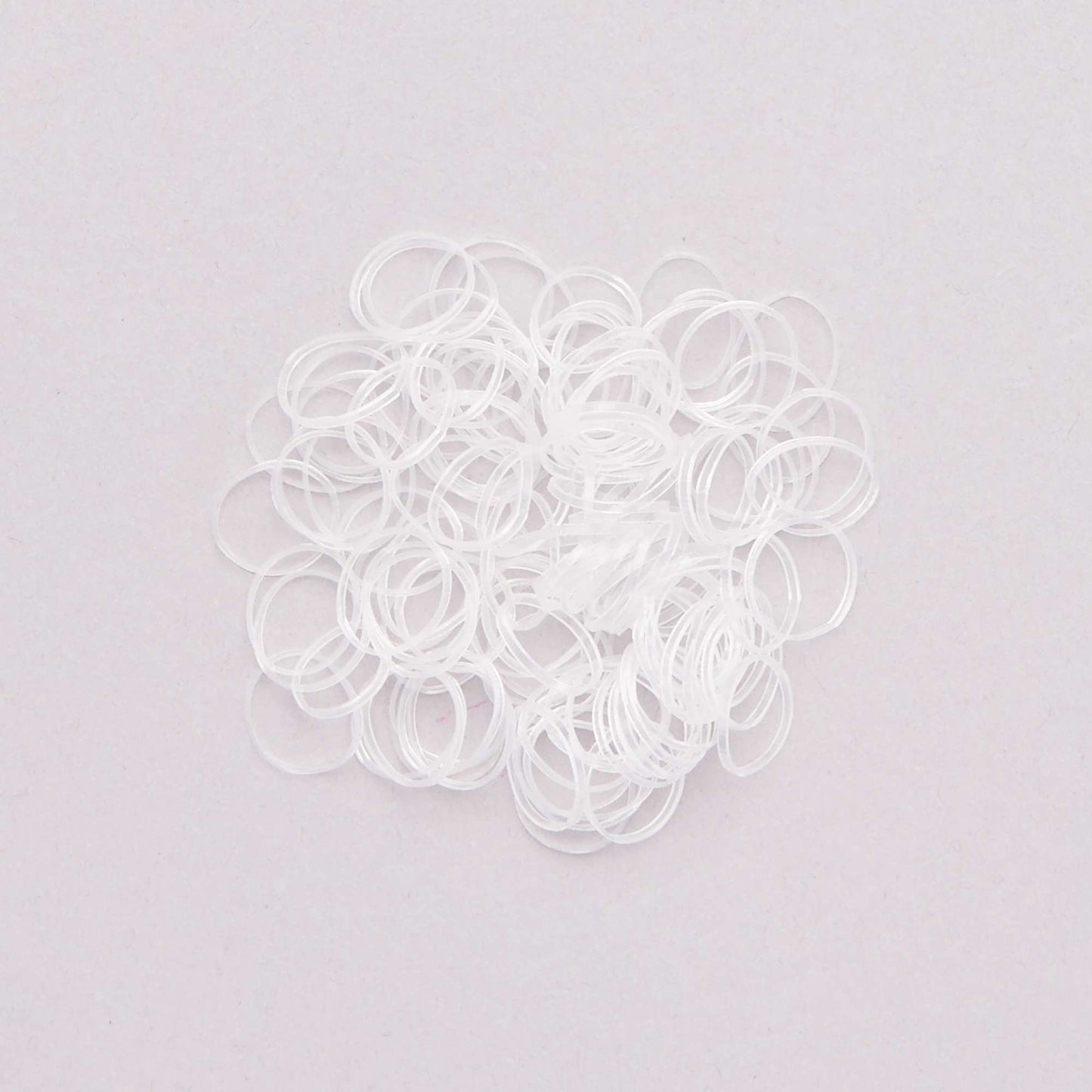 Pack of 100 transparent elasticated hair bands transparant